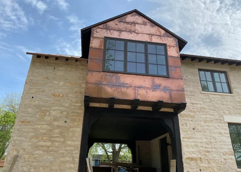 Copper metal panel facade on a stone building for Metal Roof Coating in Chippewa